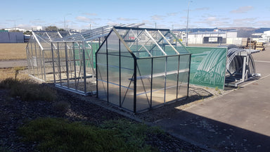 Poly-Glass Greenhouse exterior view on industrial site showing size and layout.
