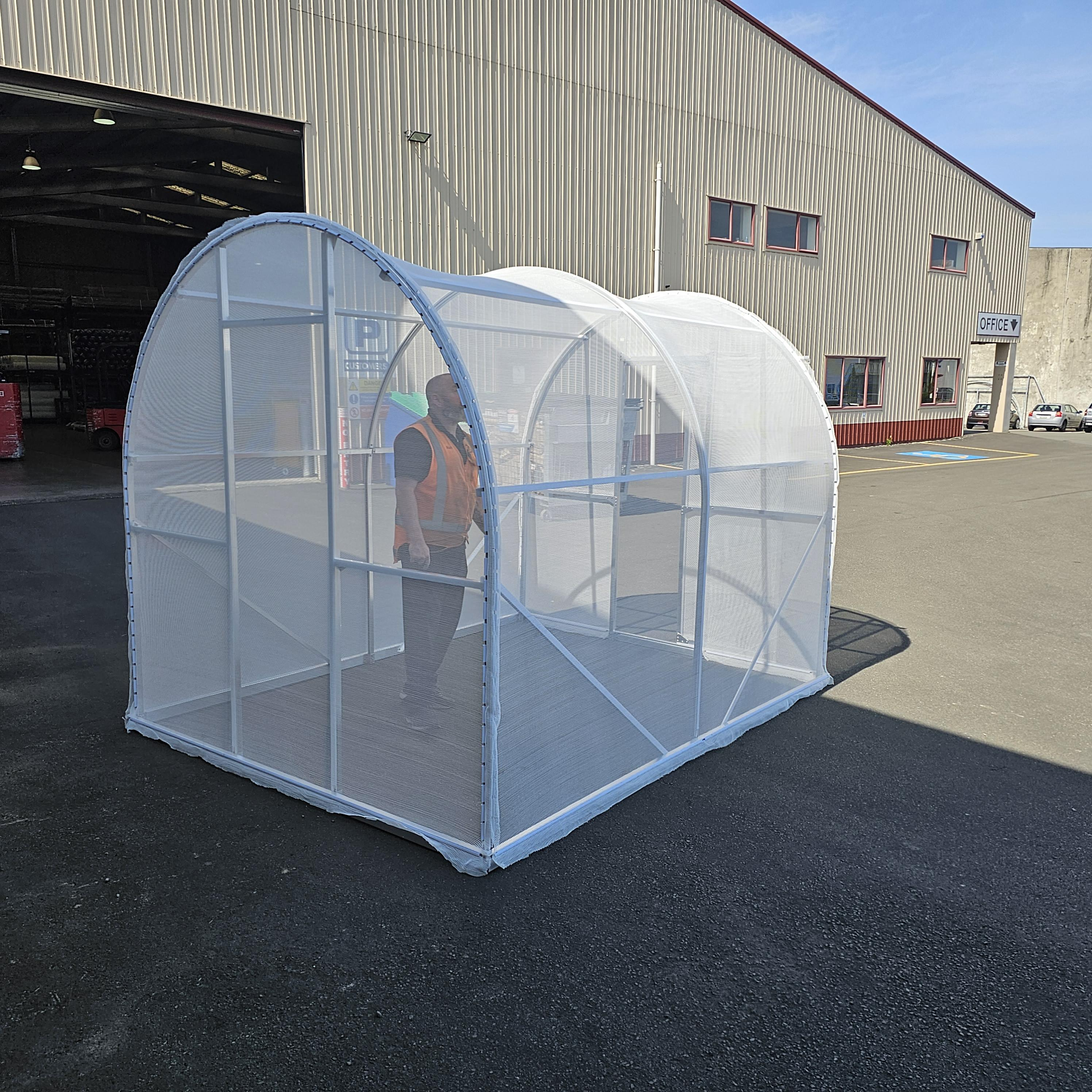 Backend of Shade House with white shade cloth and door open